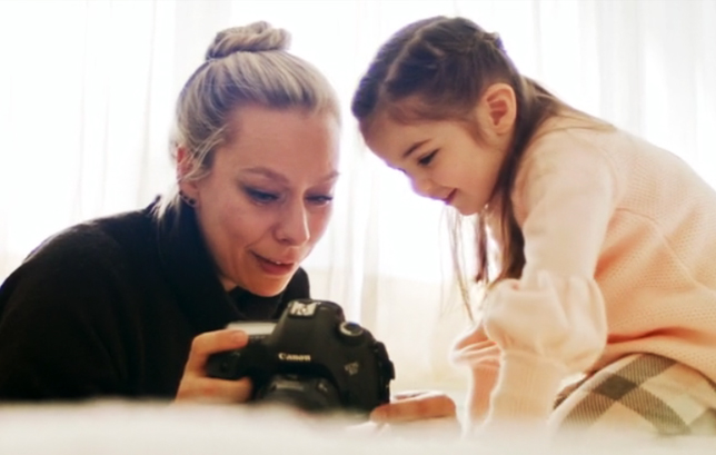 mom and daughter watching photographies on a camera