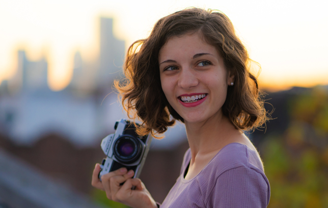 laughing woman holding a camera