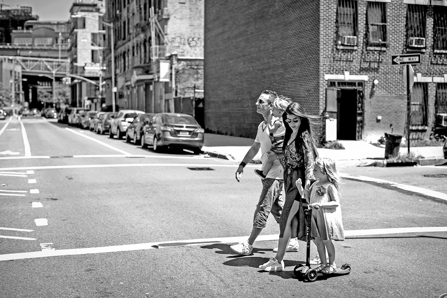 Family of four crossing a street