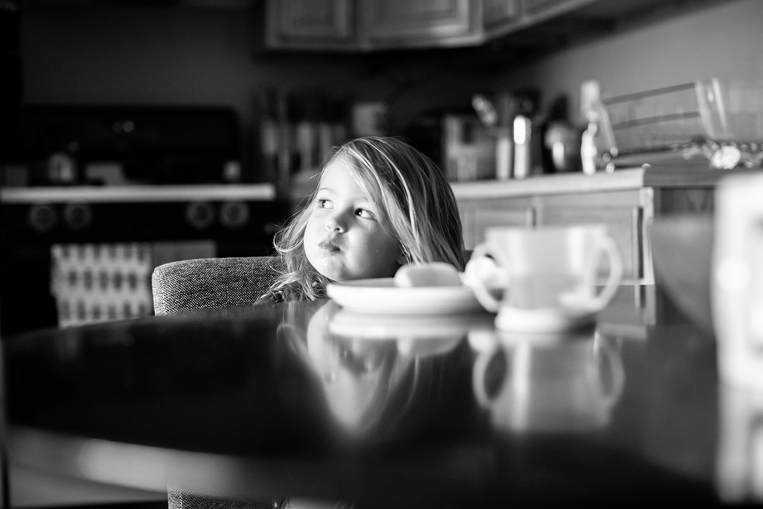 BW Toddler sitting at a table looking to the side