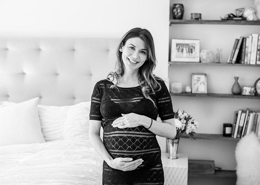 Pregnant woman smiling at the camera