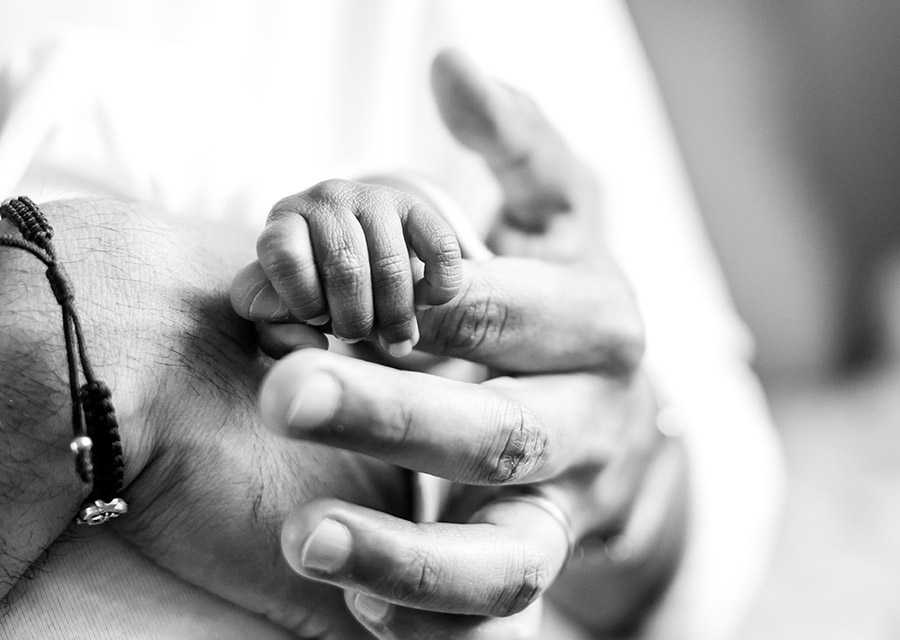 BW Newborn baby's hand hodling dad's finger