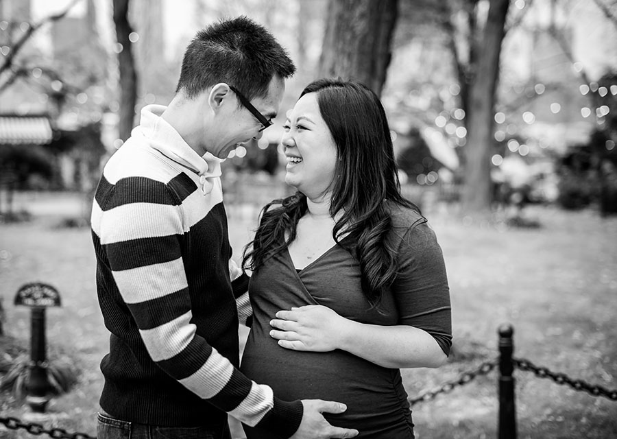 Parents-to-be smiling at each other