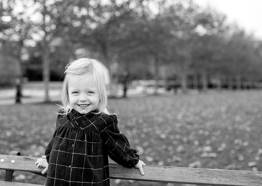 BW Little girl outside smiling at the camera