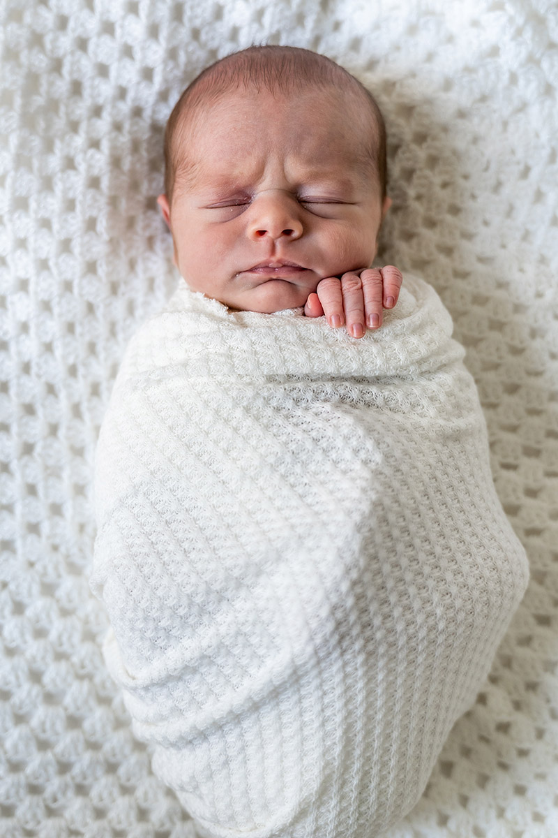Newborn baby swaddled in a blanket