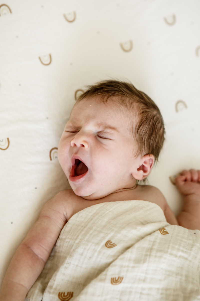 Sleeping newborn baby yawning