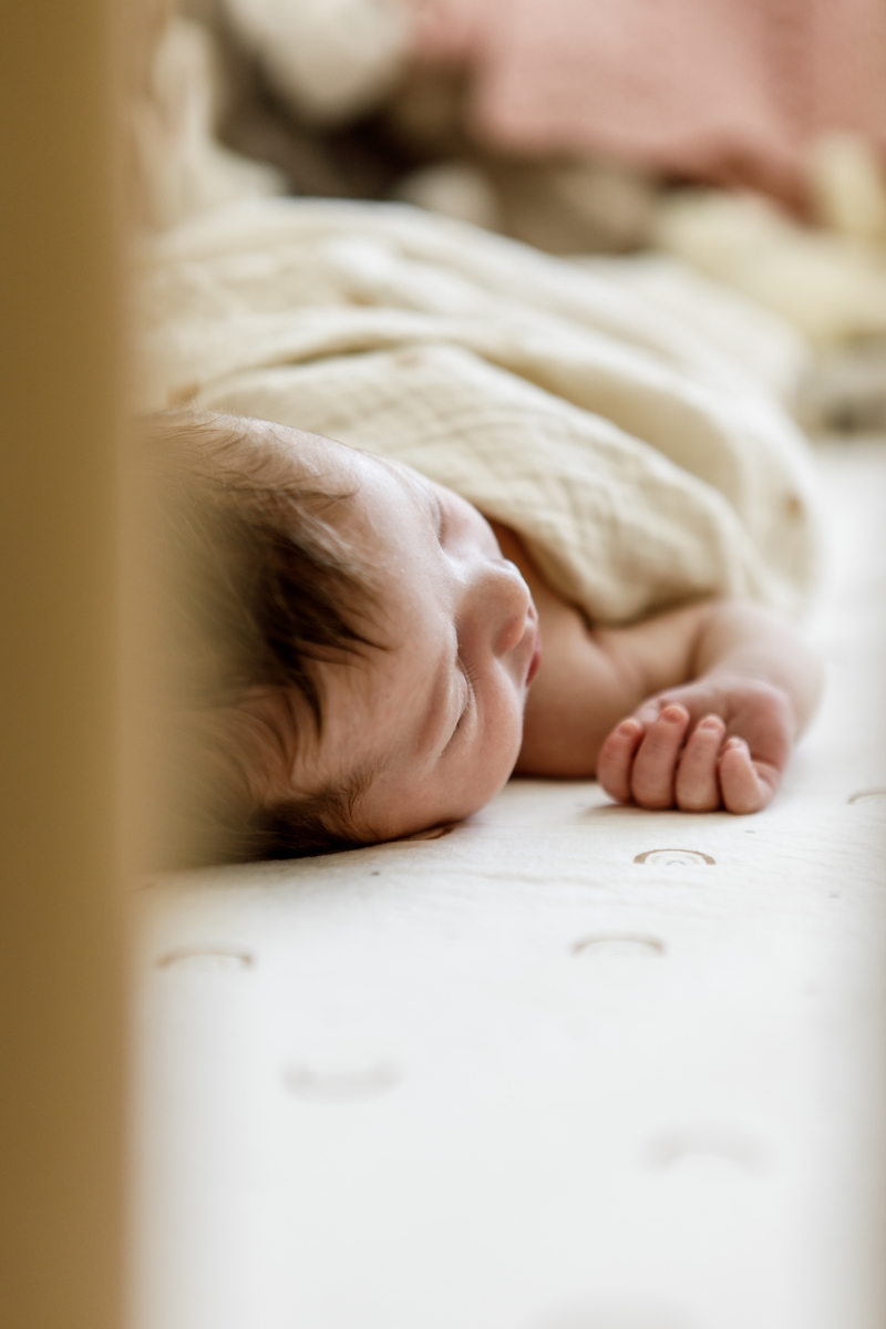 Sleeping newborn baby in a crib
