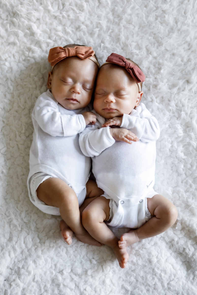 Newborn twin babies laying next to each other