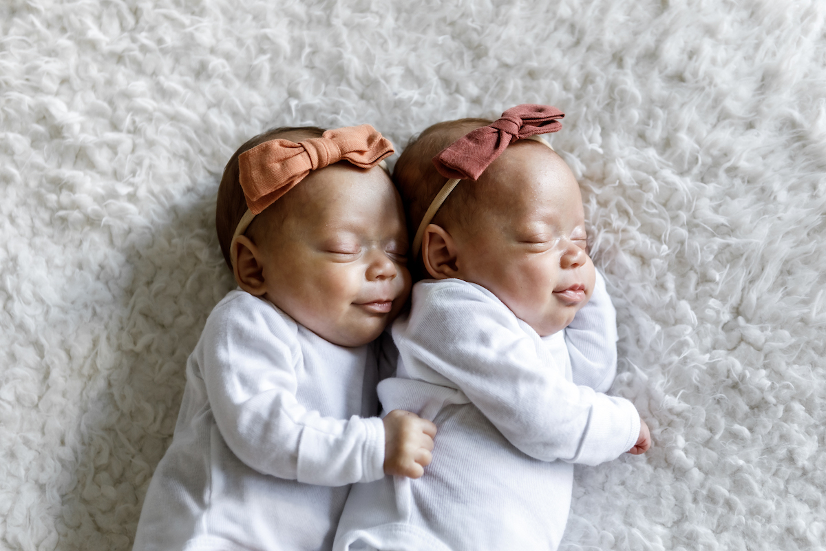 Newborn twin babies laying next to each other