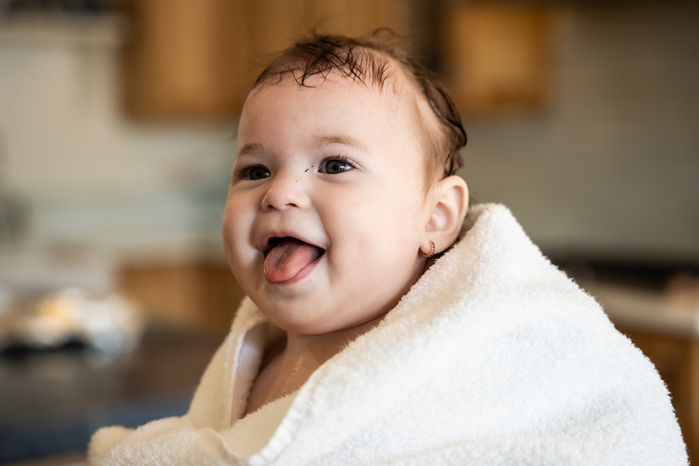 Girl wrapped in towel after bath sticking her tongue out
