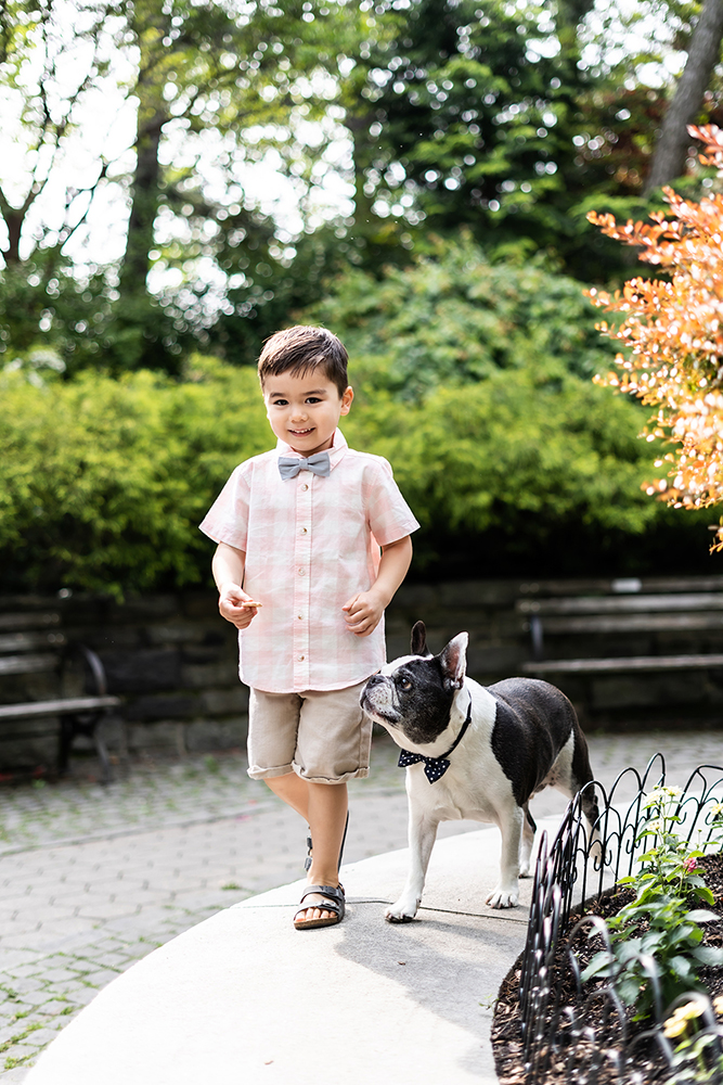 boy with bowtie walking his doggy