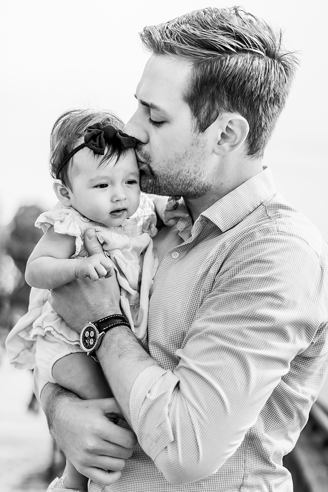 Daddy kissing his toddler girl