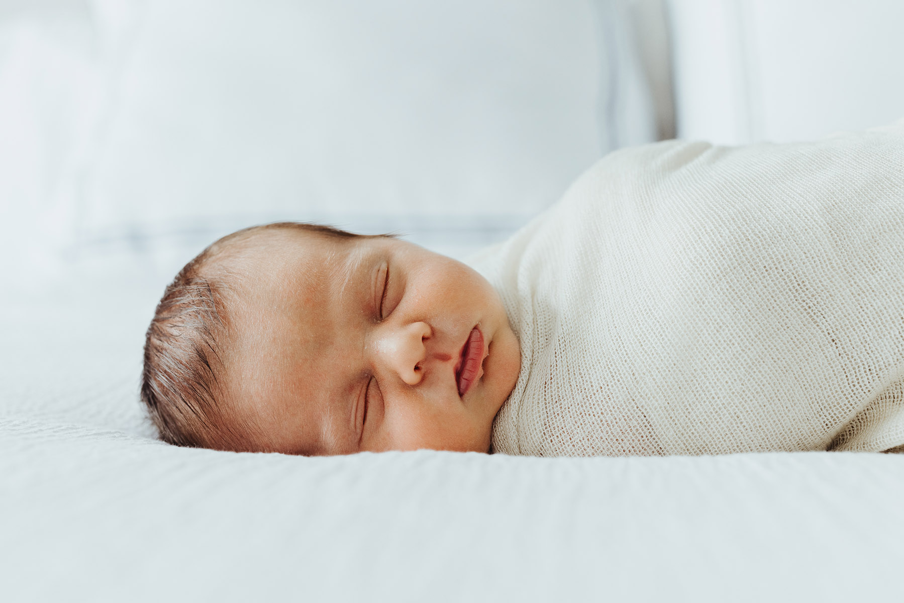 portrait of sleeping newborn laying in bed