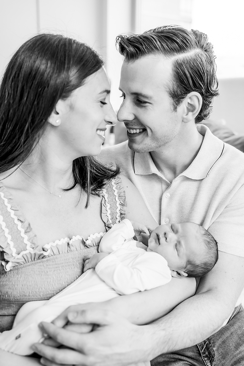 Black and white family photo with newborn baby