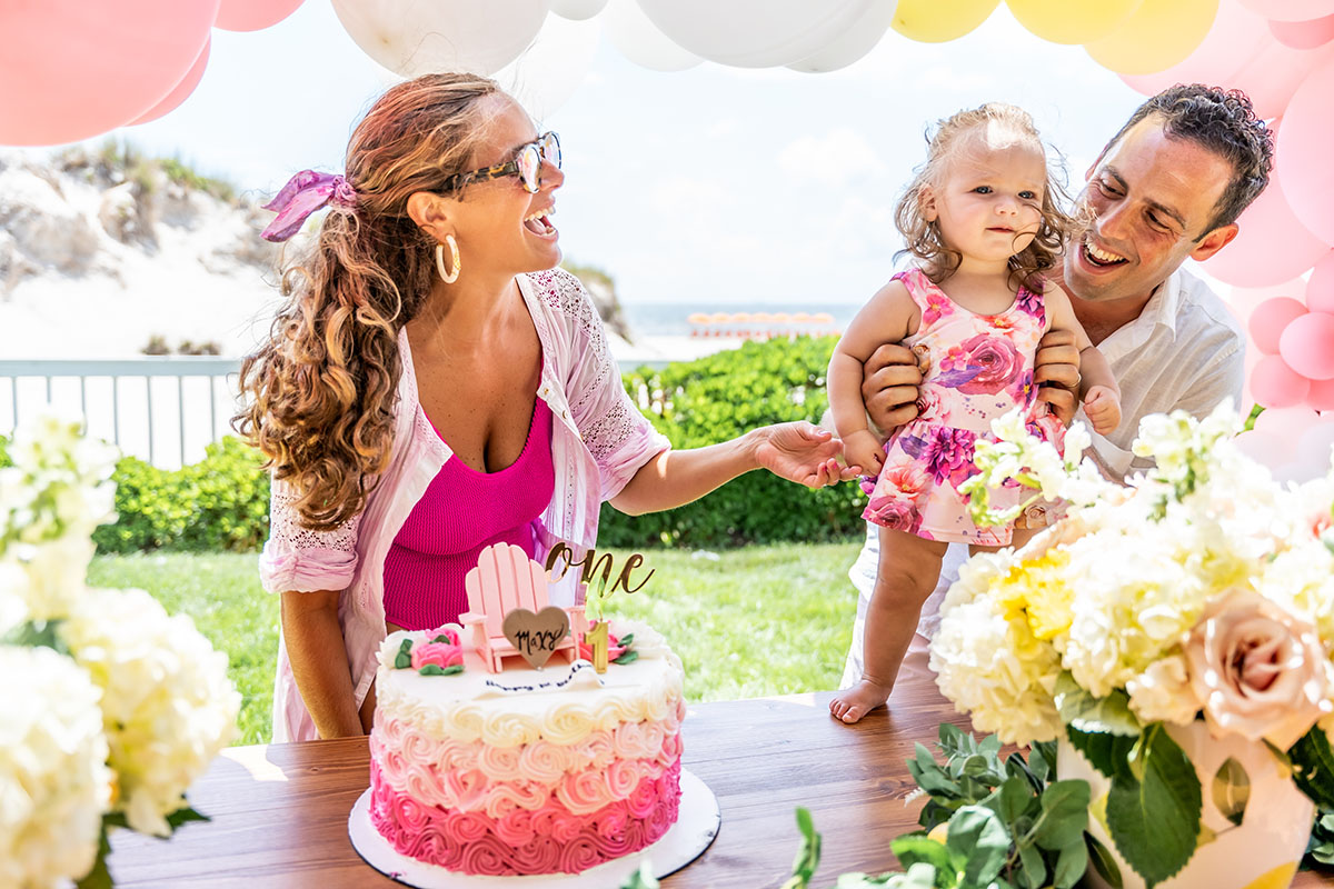 family portrait at a table with cake and flowers frontview