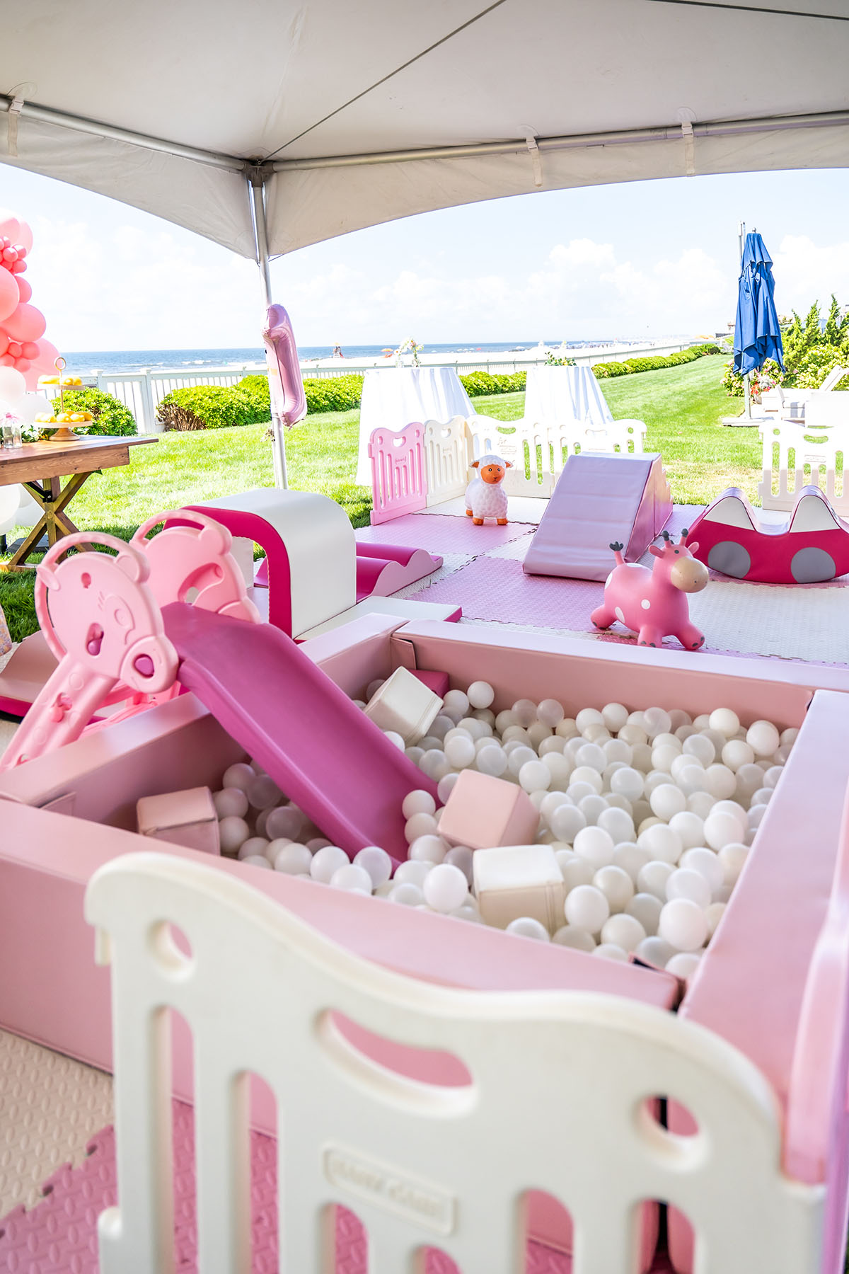 pink ball pool with slide under pavillon