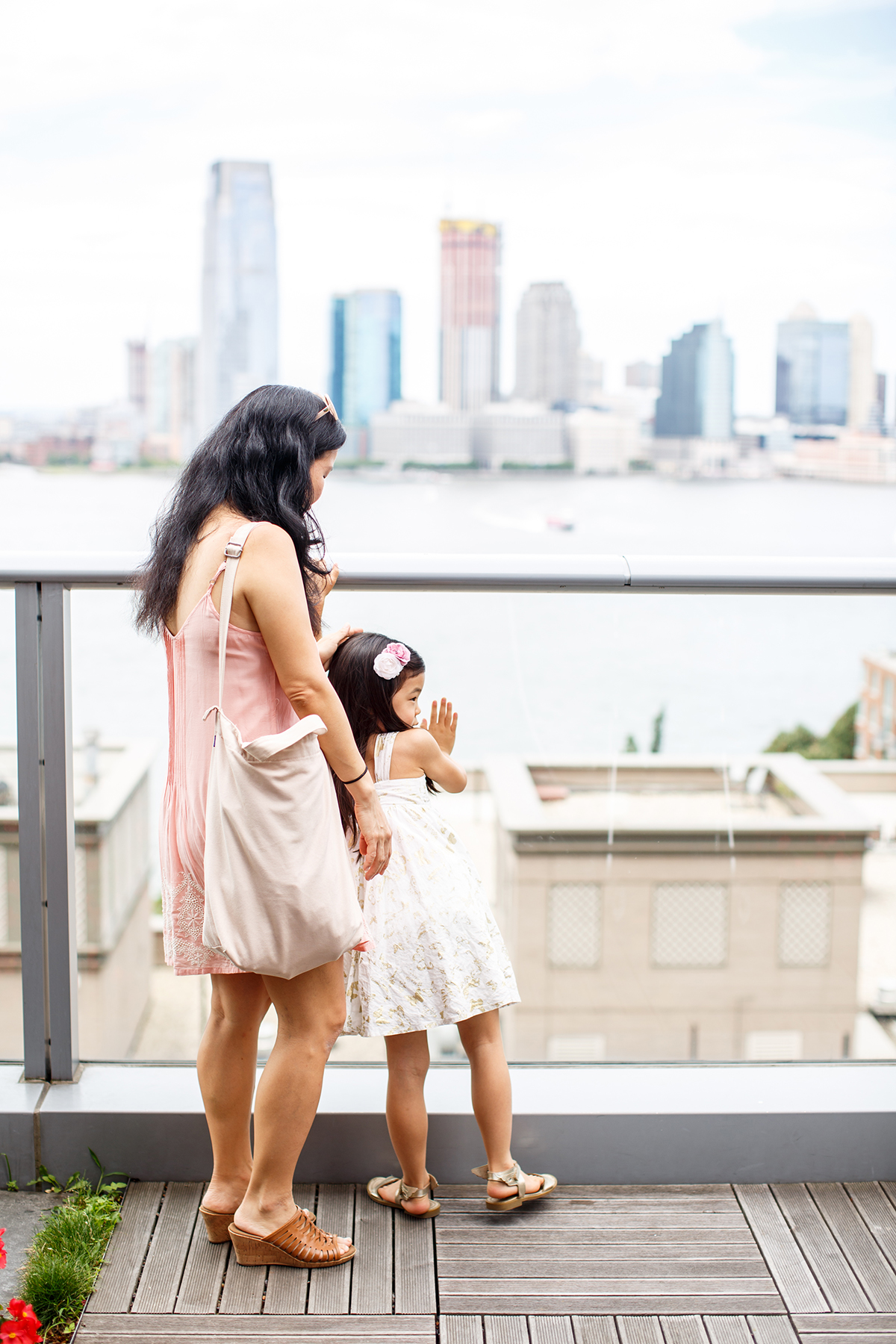 Mother and child enjoying the skyline of Queens