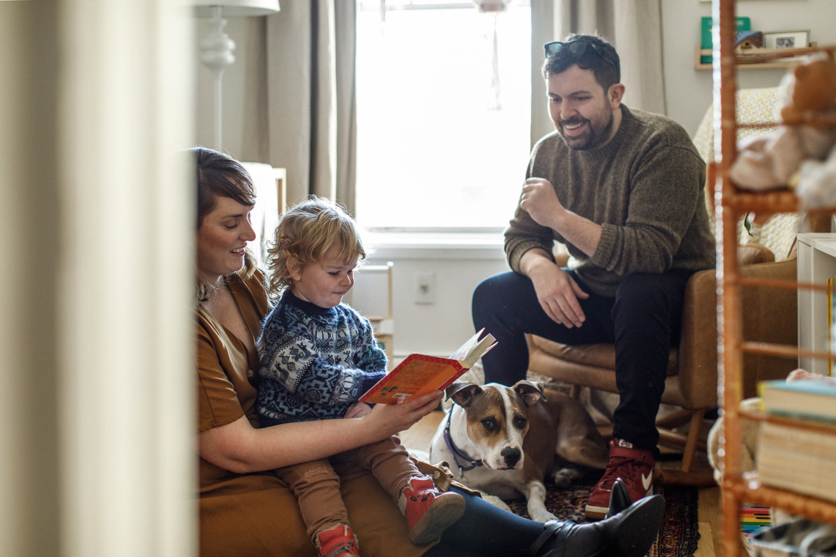 family with dog reading kids books happy time
