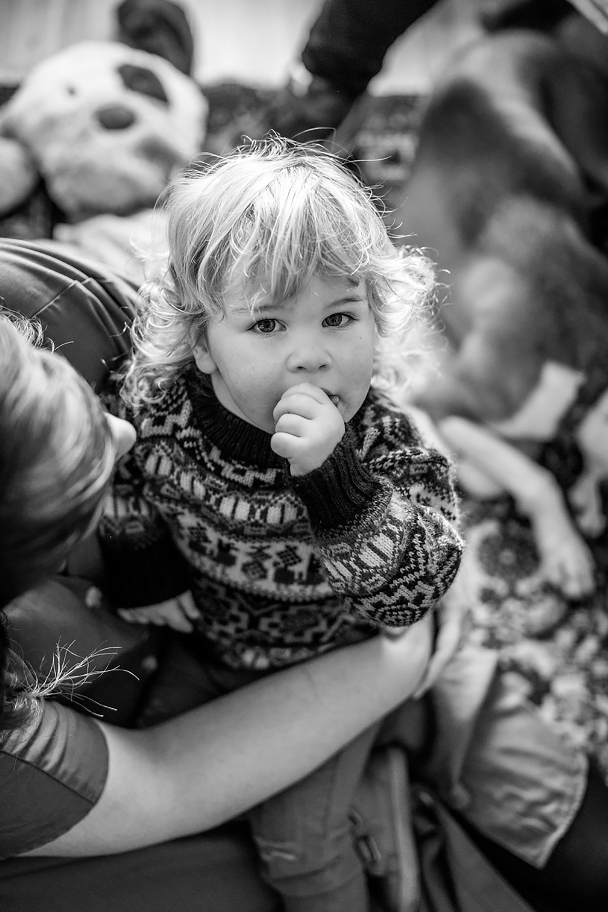 BW blond toddler on the lap of his mom looking in the camera