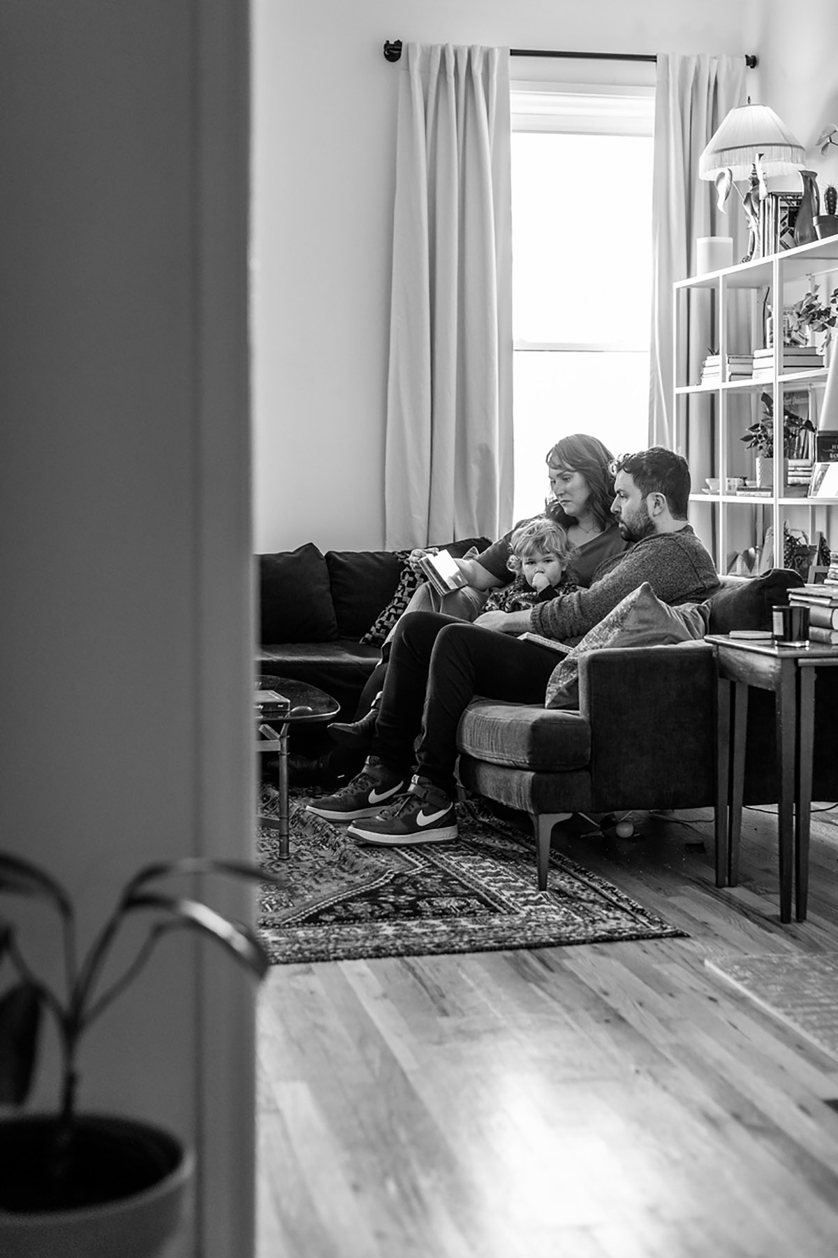 BW photo of family reading on couch in Brooklyn