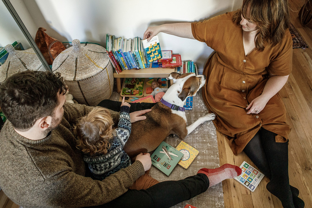 family sitting on the floor choosing a kids book