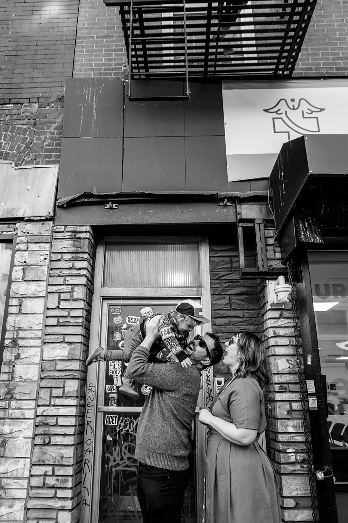 BW photo of family in front of their house in Brooklyn