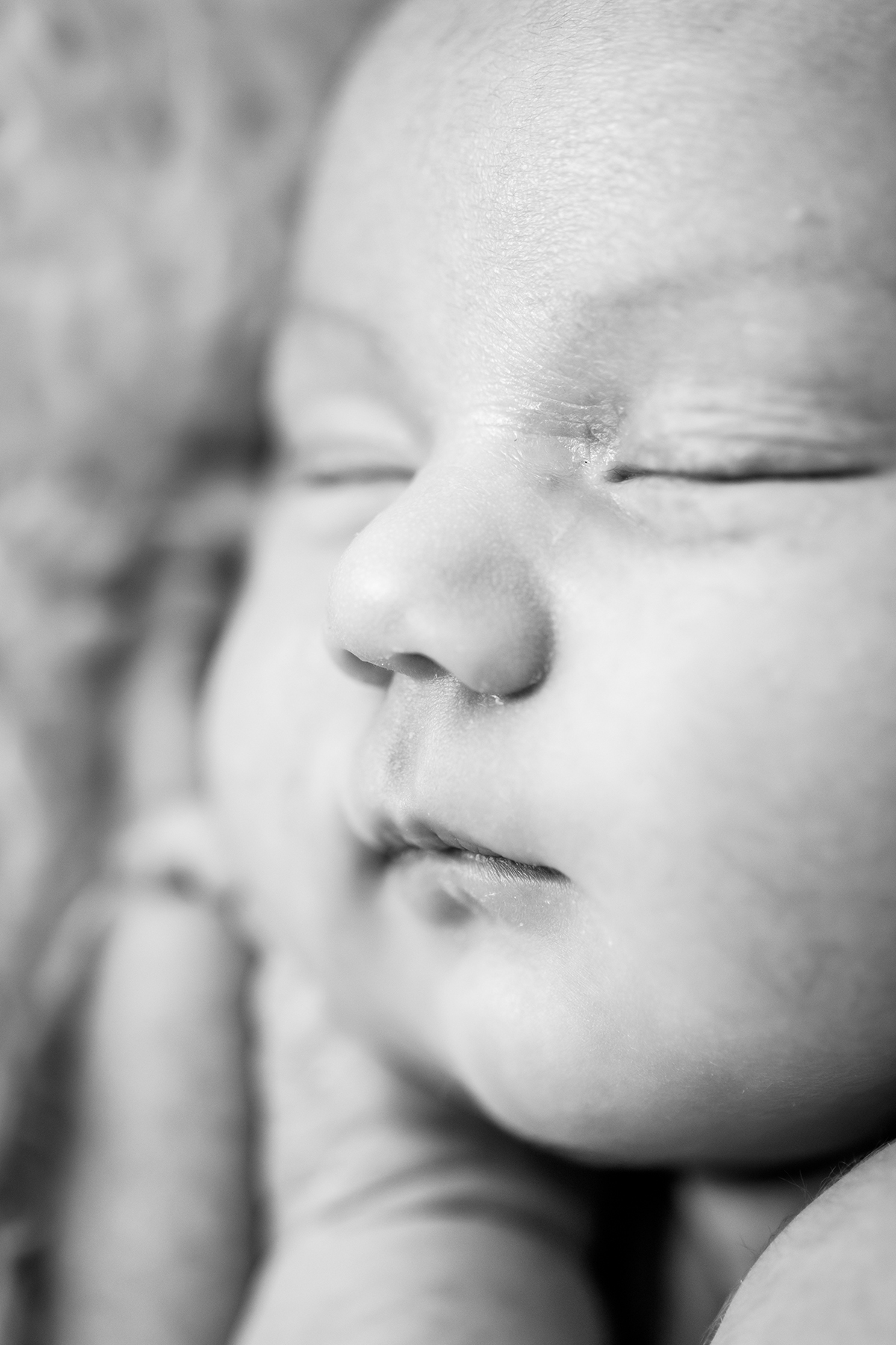 Close up of newborn baby face in BW