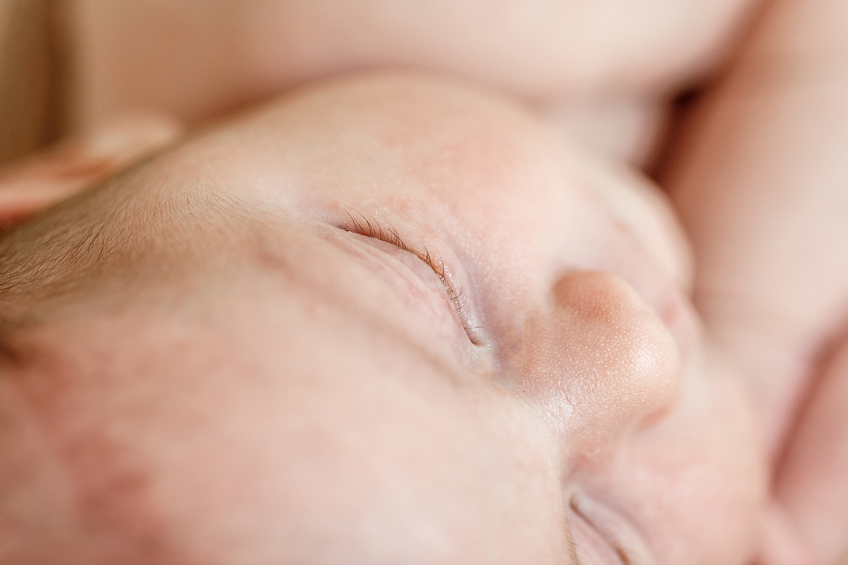 Close up of a sleeping newborn baby's eye and nose