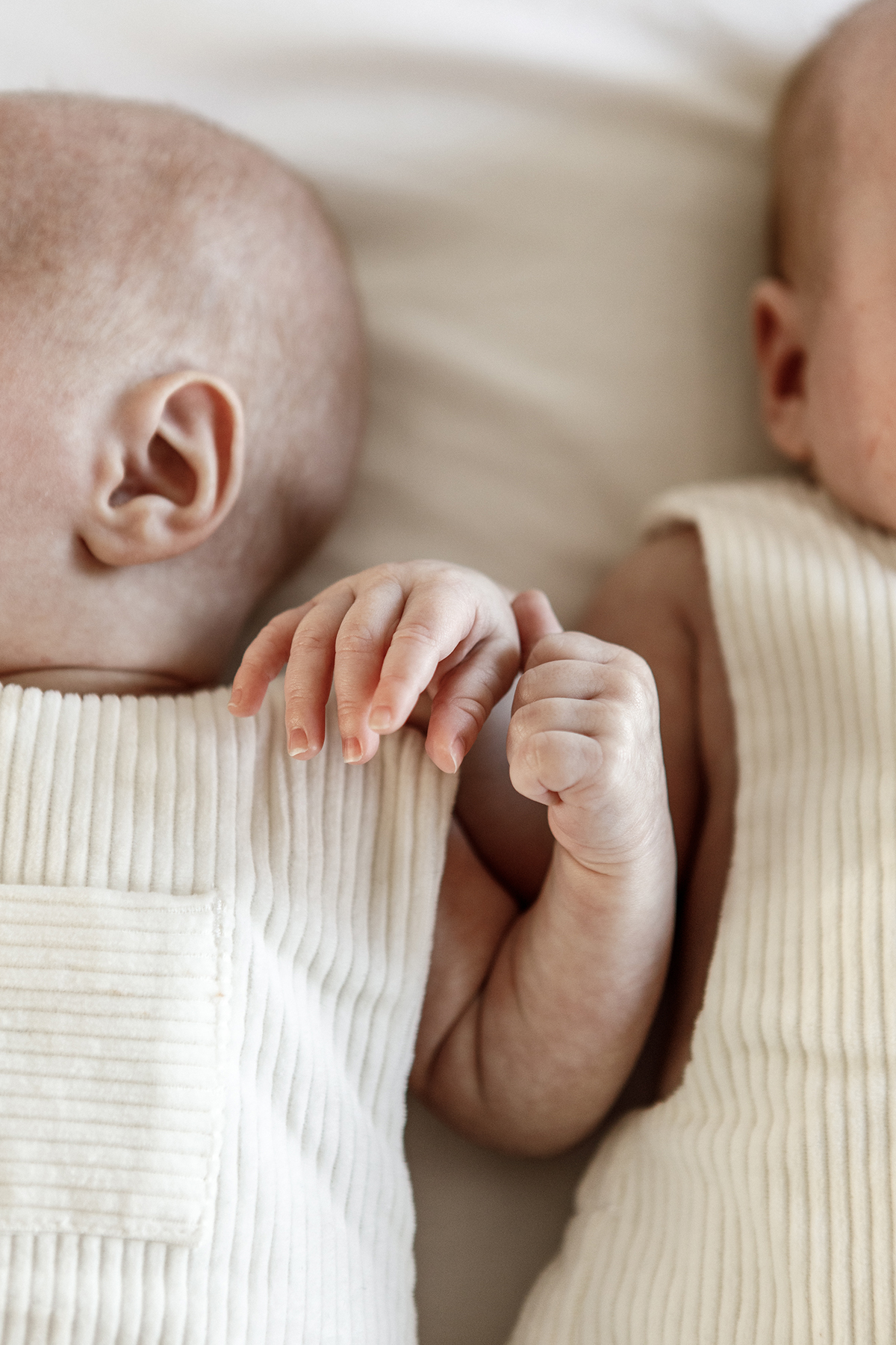 closeup of hands of newborn twins
