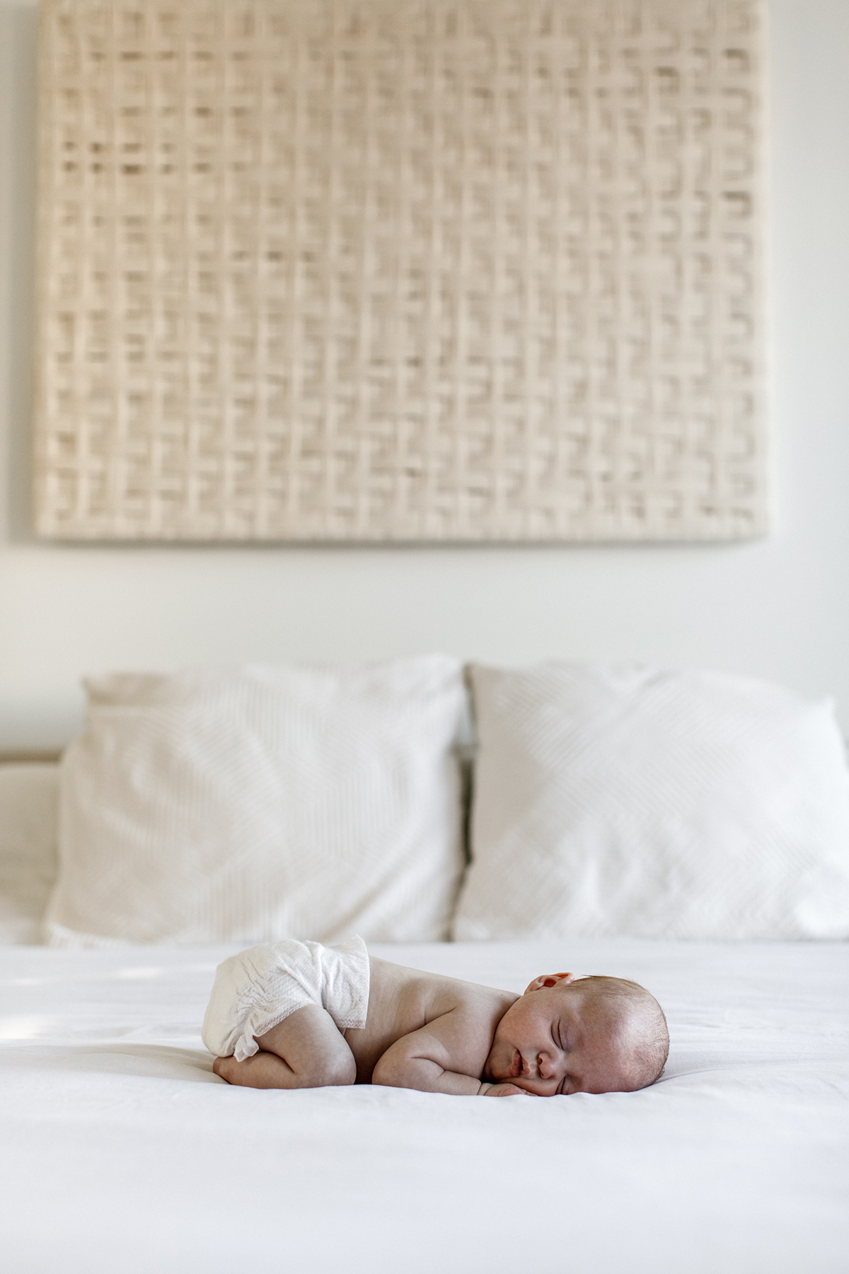 long shot of peacefully sleeping baby in bed