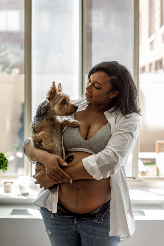 pregnant woman holding her dog