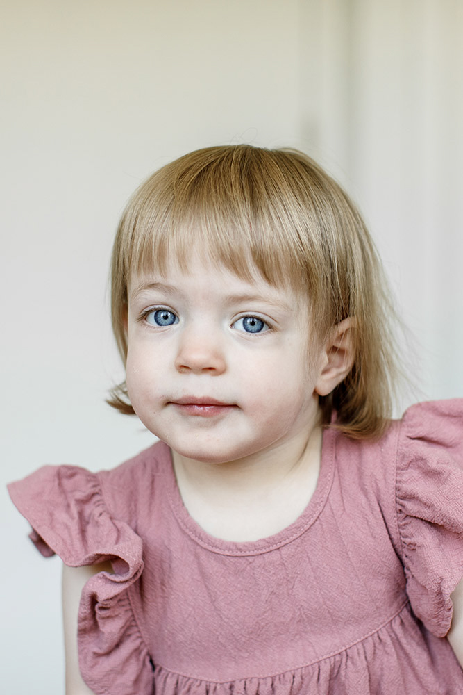 portrait of beautiful girl with blue eyes and pink dress