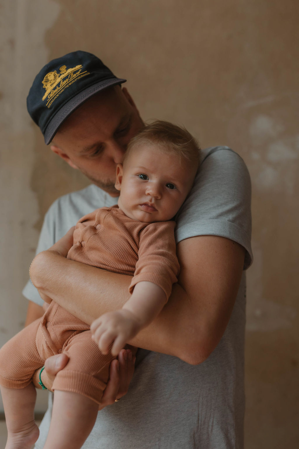 dad kissing his 3 month old boy