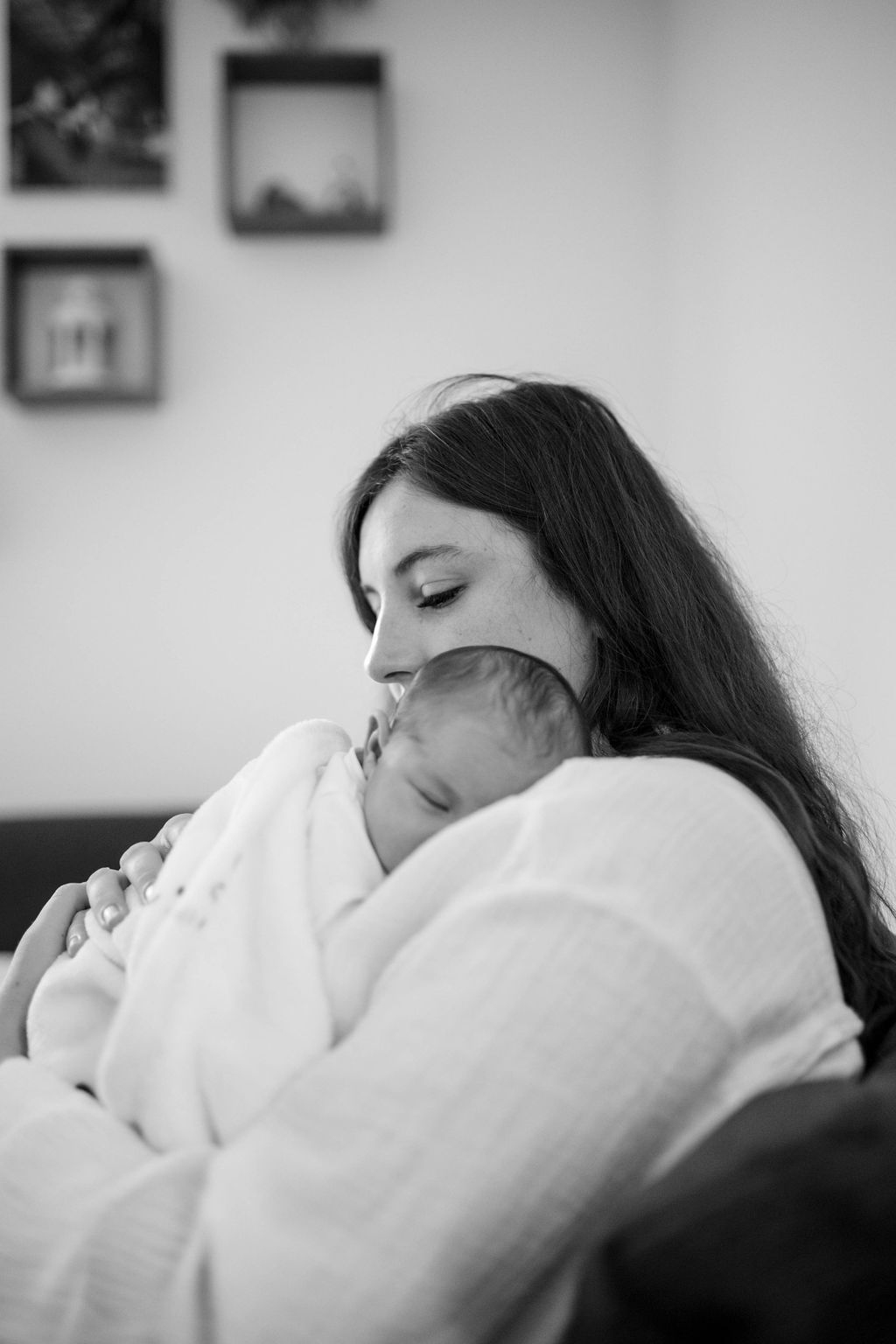 BW mommy holding her sleeping newborn baby