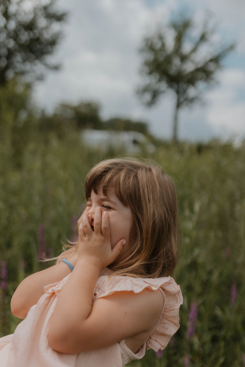 girl holding her mouth because something is so funny