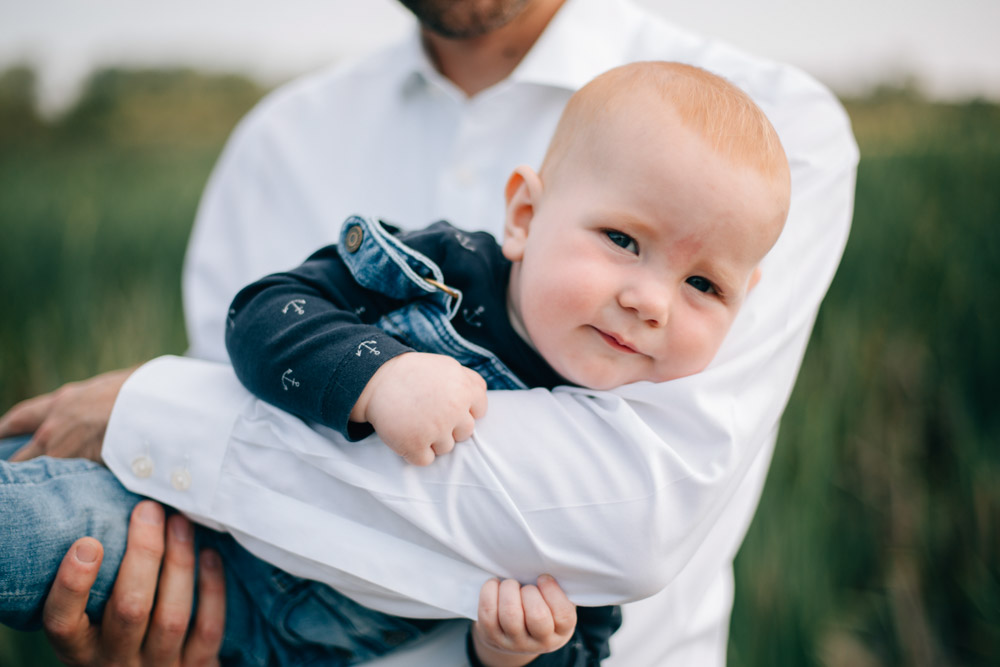 close up of a son being held by his father