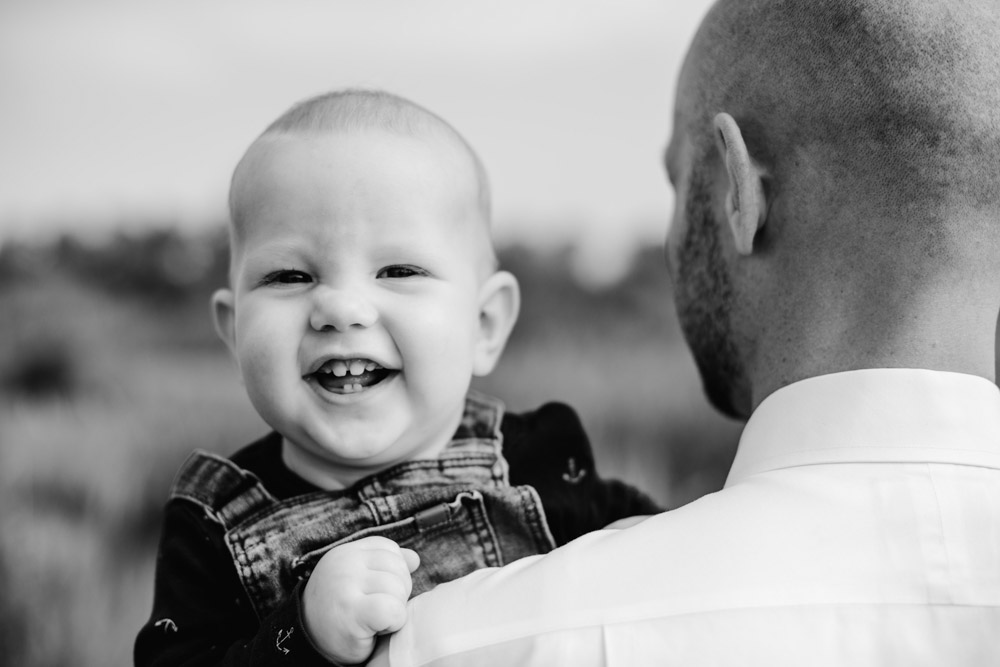 BW photo of boy being held by his dad