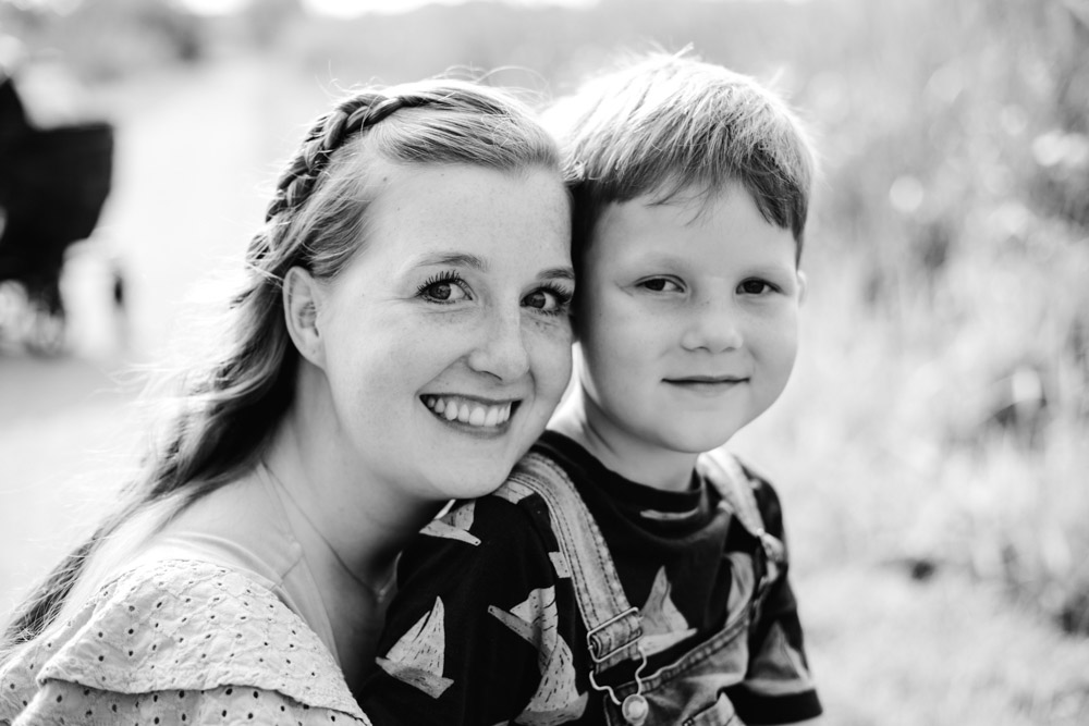 black and white photo mother and son smiling at the camera