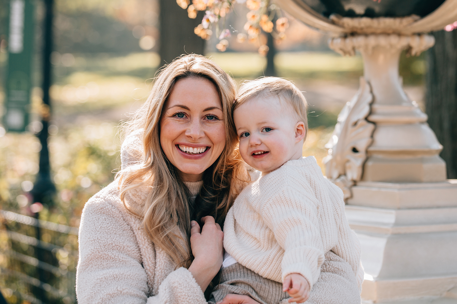 close up of mother and her daughter both smiling at the camera in Central Park in a Fall mood