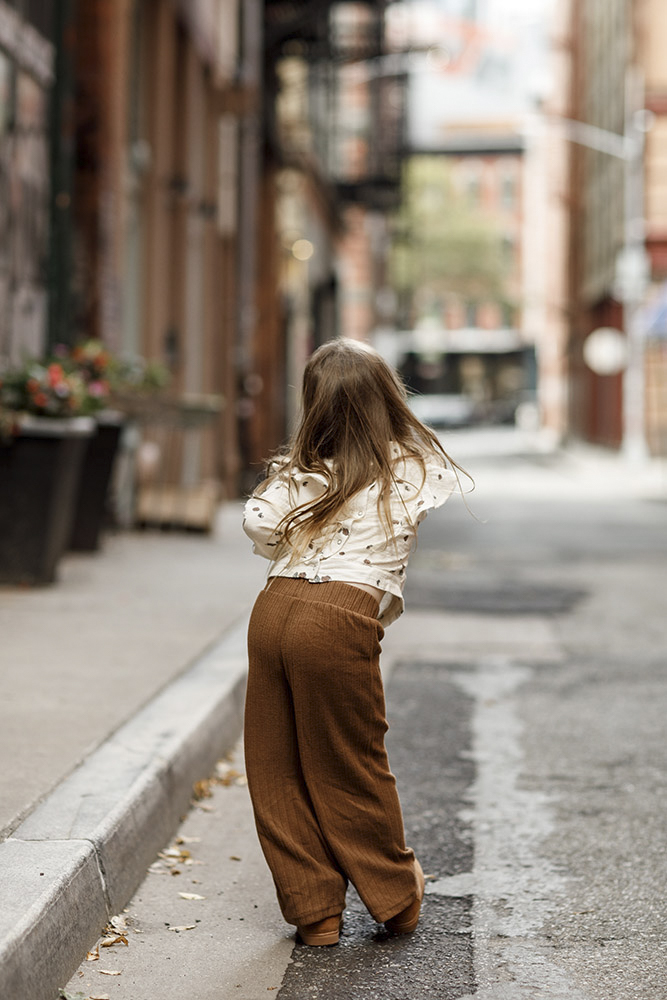 back view of a little girl with long hair in the streets of New York