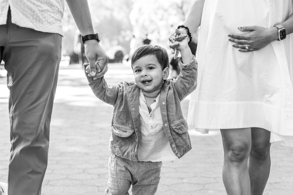 Family Photos, black and white photo of toddler walking between mother and father holding both hands
